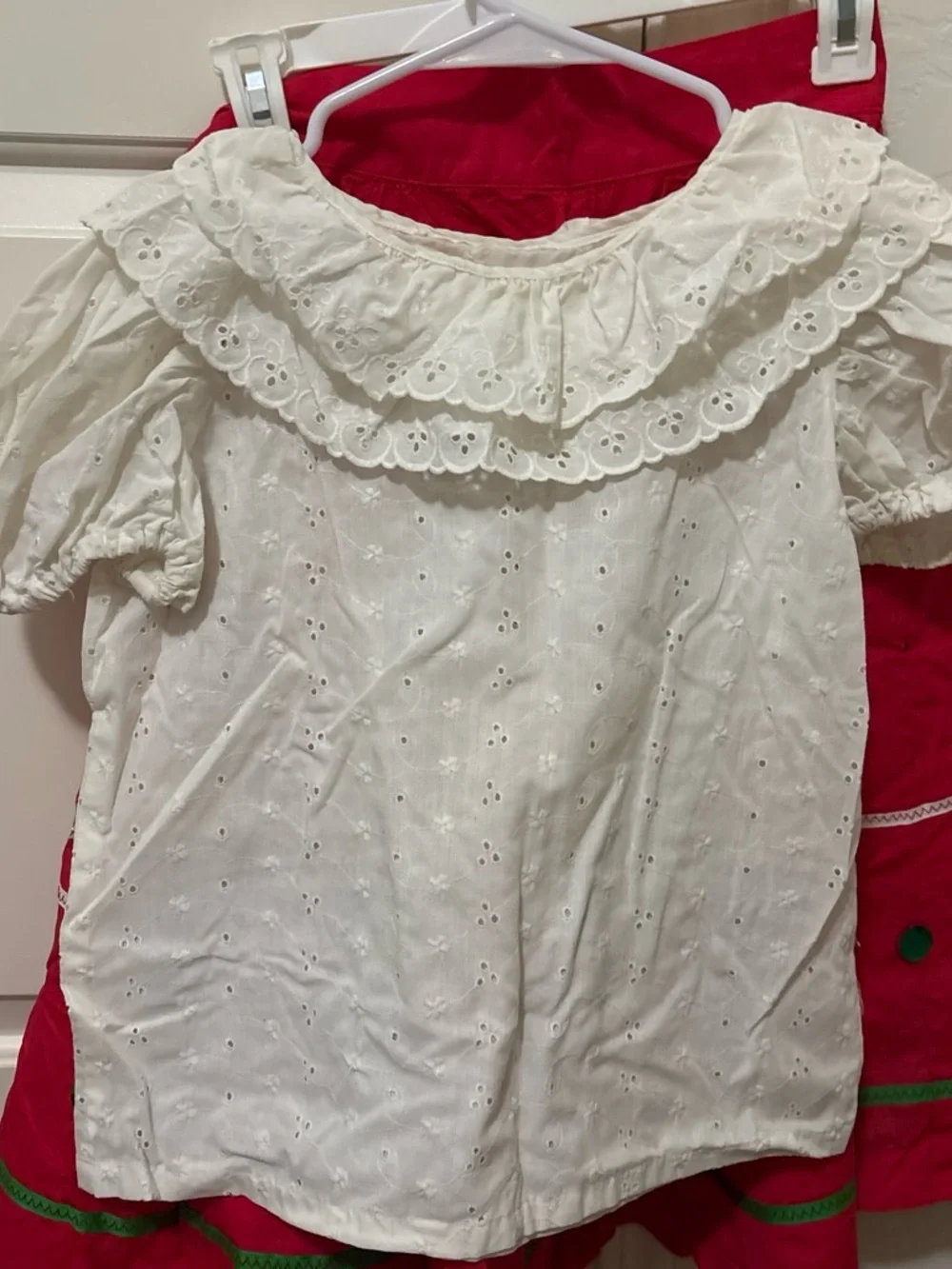 Folclórico Red skirt with white polka dots and green trim, with a white top and